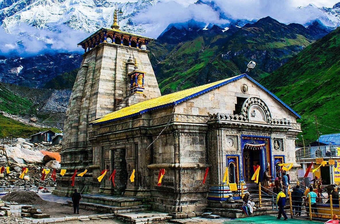 Pilgrims trekking to Kedarnath temple during Do Dham Yatra group tour in Himalayas