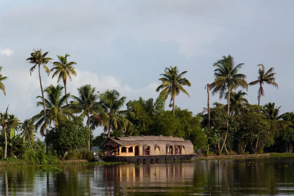 Travelers enjoying Kerala group tour with houseboat and nature views